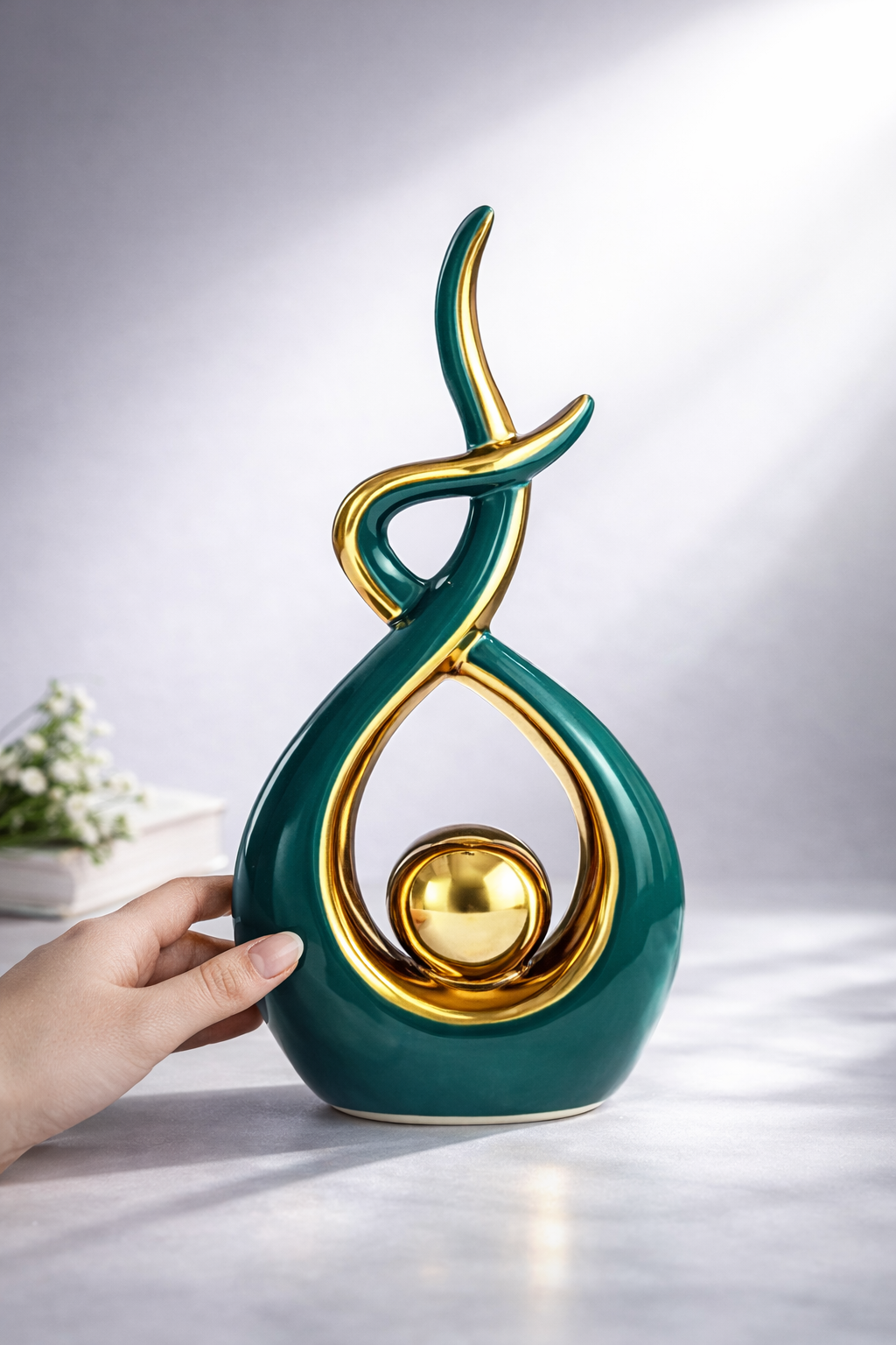 Green and gold ceramic sculpture size reference in hand