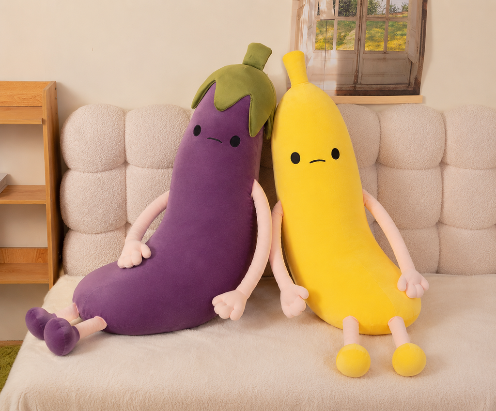 Banana and eggplant plush pillows on sofa
