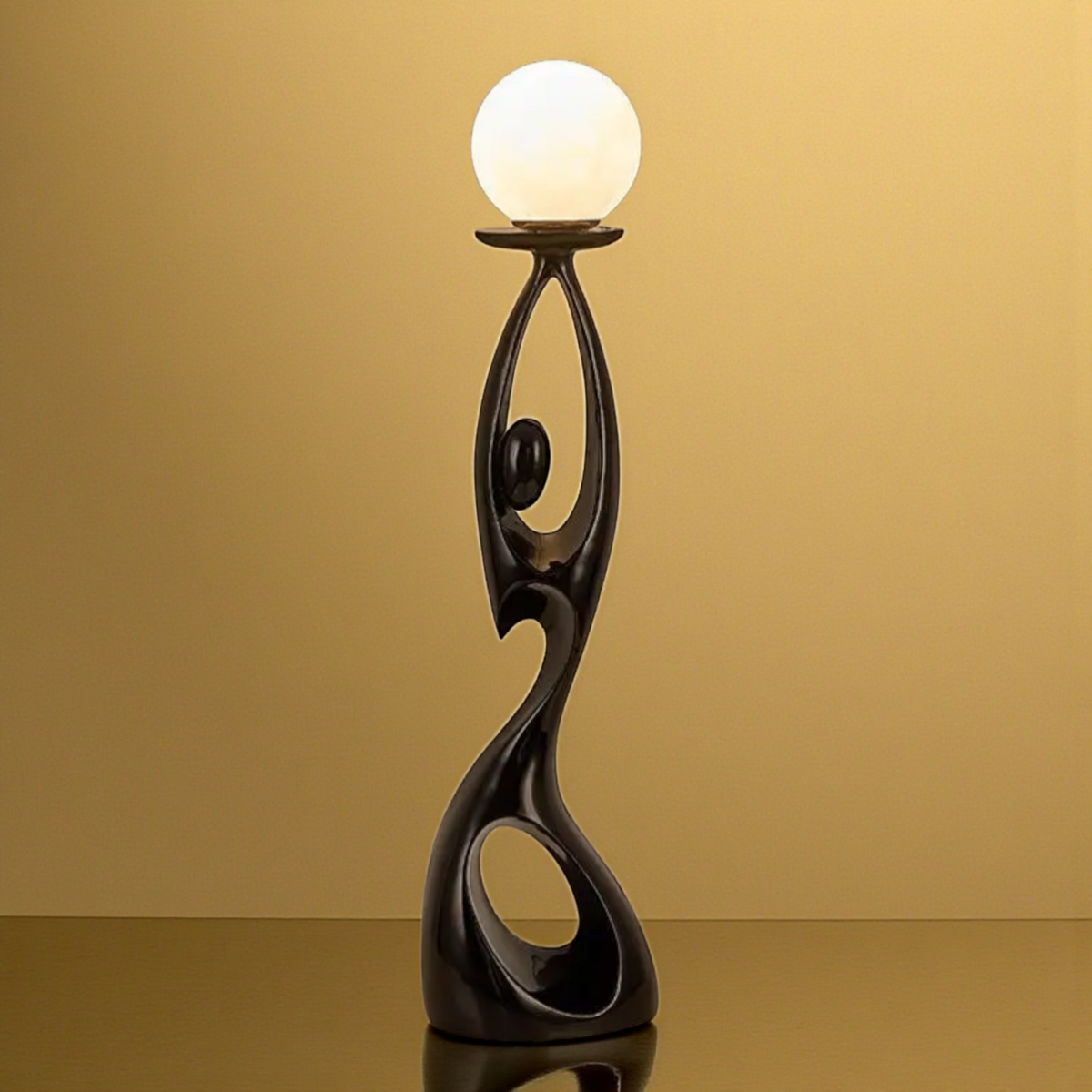 Black abstract floor sculpture with globe lamp