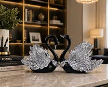 Black and silver swan figurines in a luxury interior
