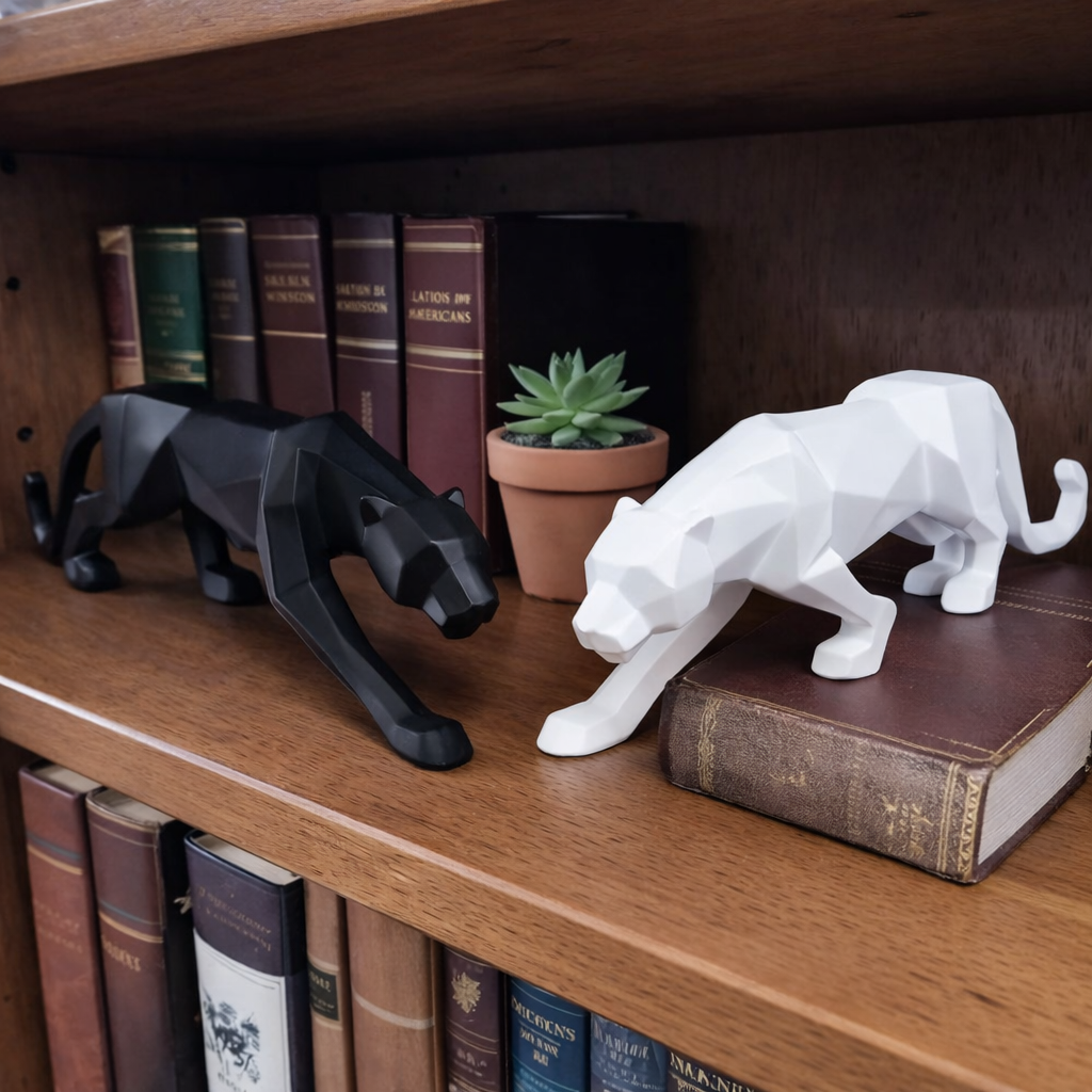 Black and white geometric panther sculptures on bookshelf