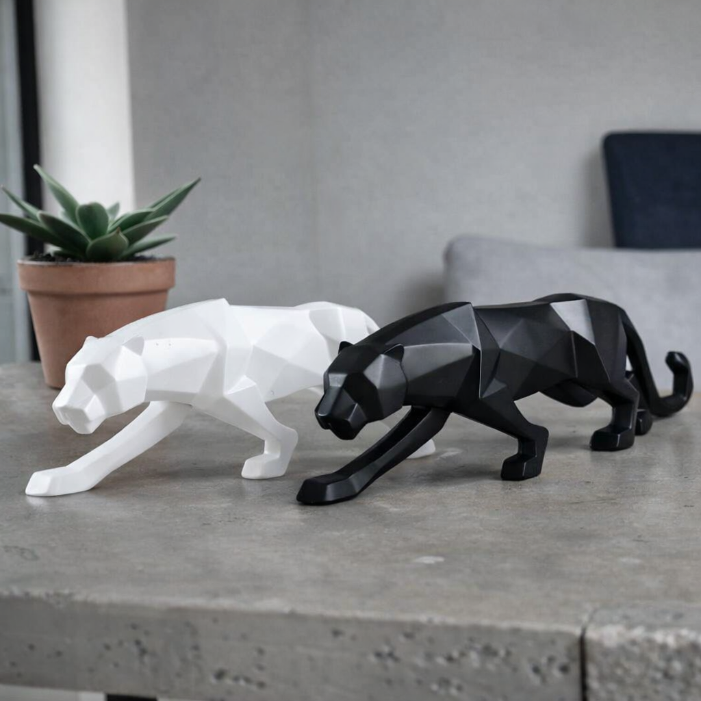 Geometric black and white panther sculptures