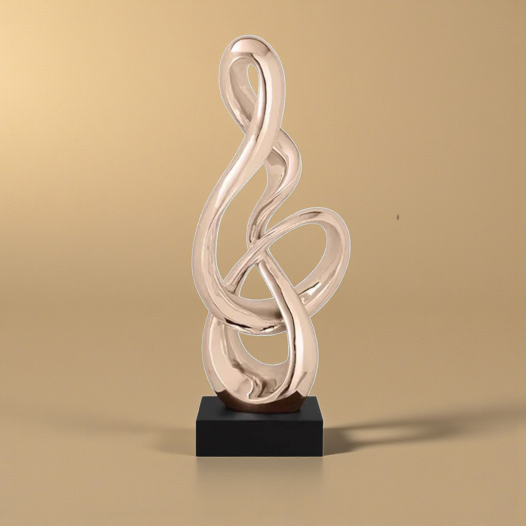 Gold abstract treble clef sculpture with black base