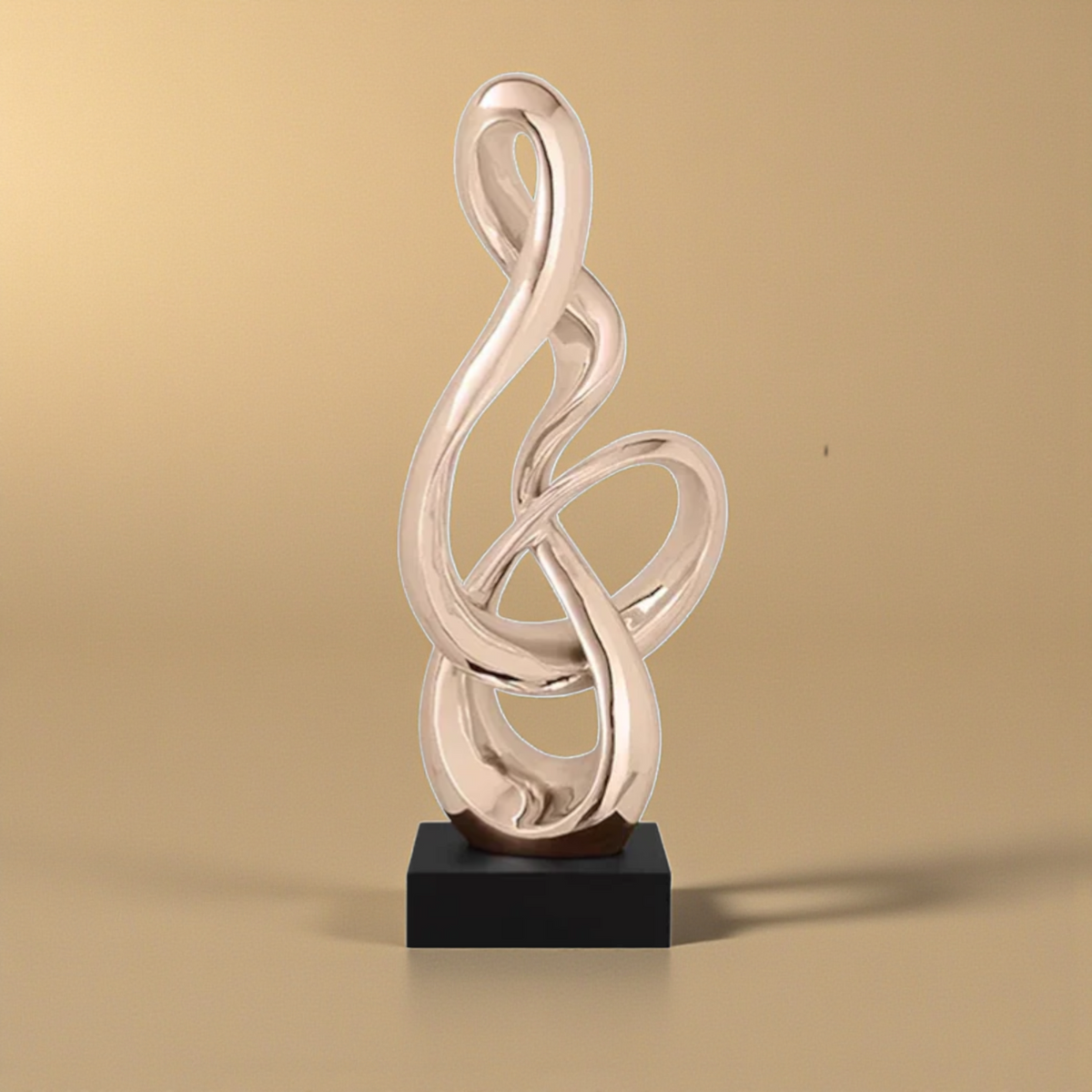 Gold abstract treble clef sculpture with black base