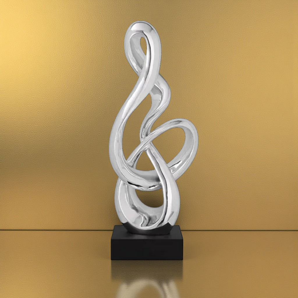 Silver abstract treble clef sculpture with black base