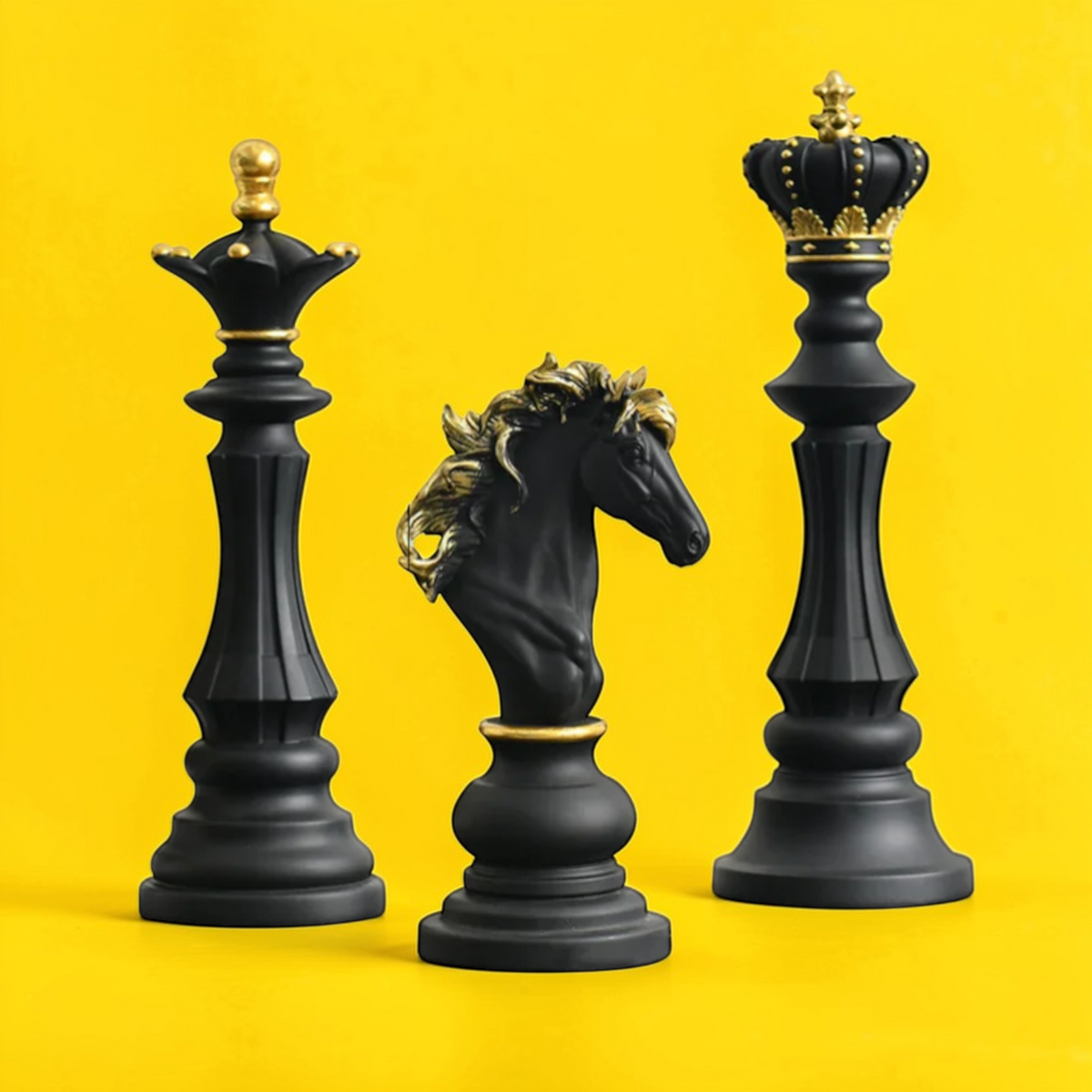 Black chess sculpture set with gold accents on yellow background