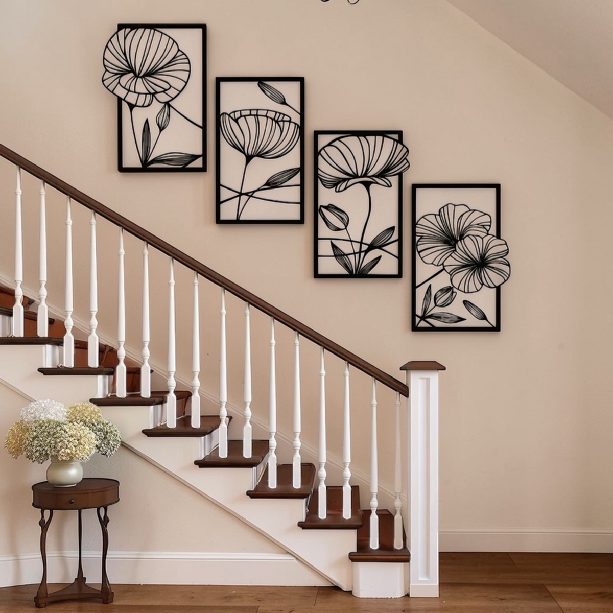 Black floral metal wall decor set displayed beside staircase