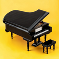 Black miniature grand piano model with matching bench