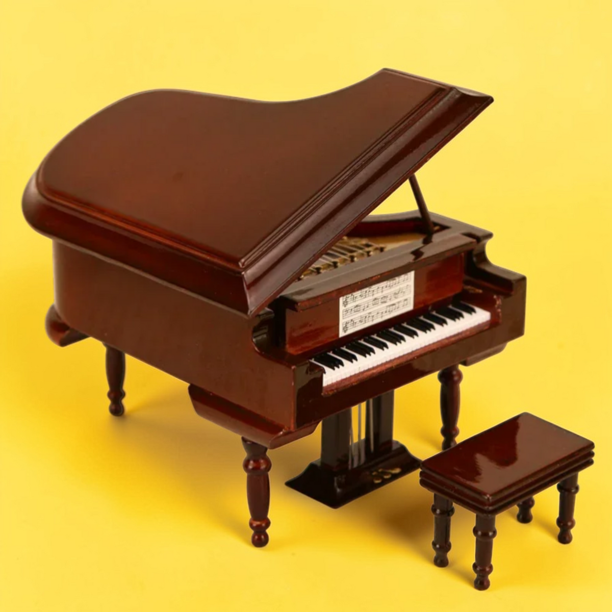 Brown miniature grand piano model with matching bench