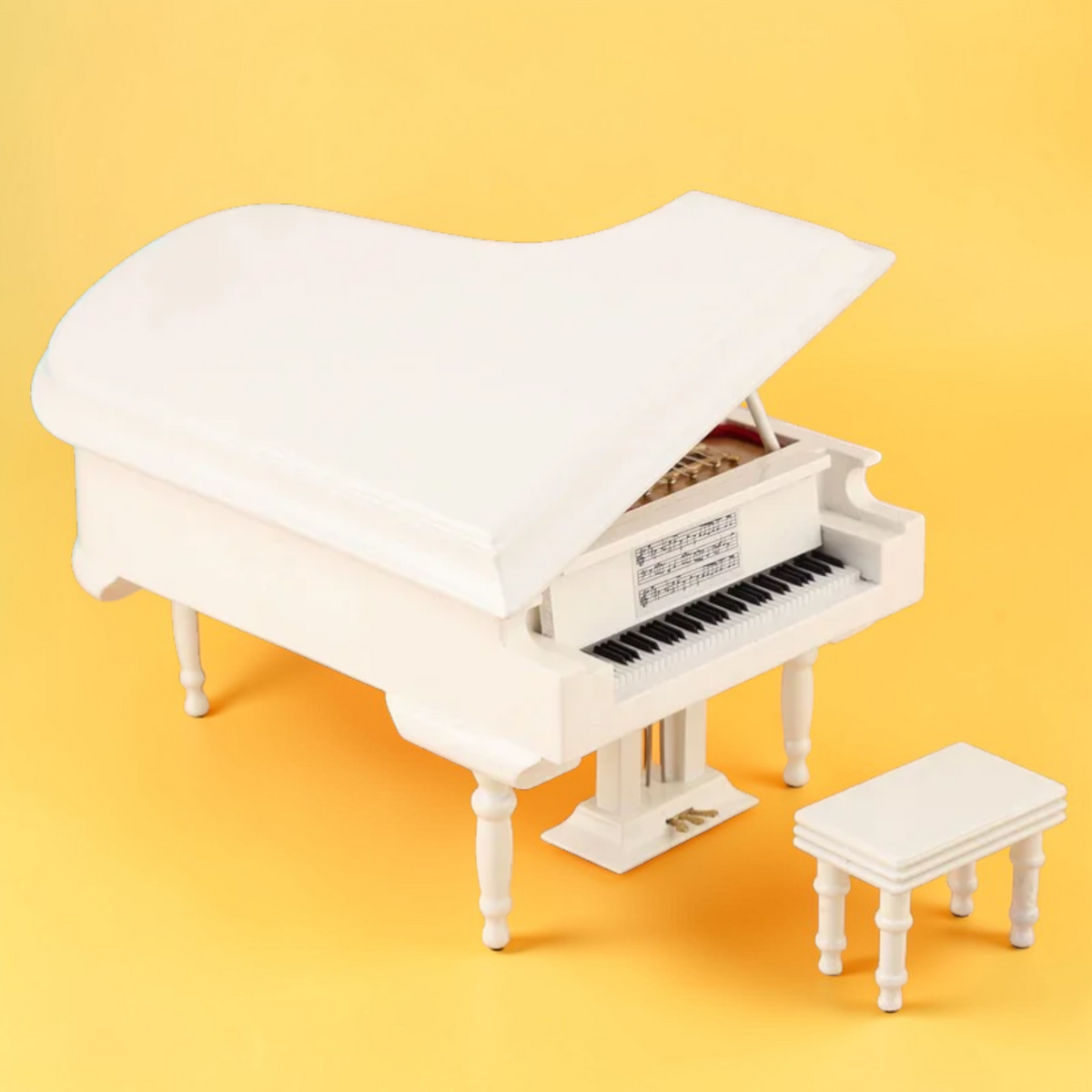 White miniature grand piano model with matching bench