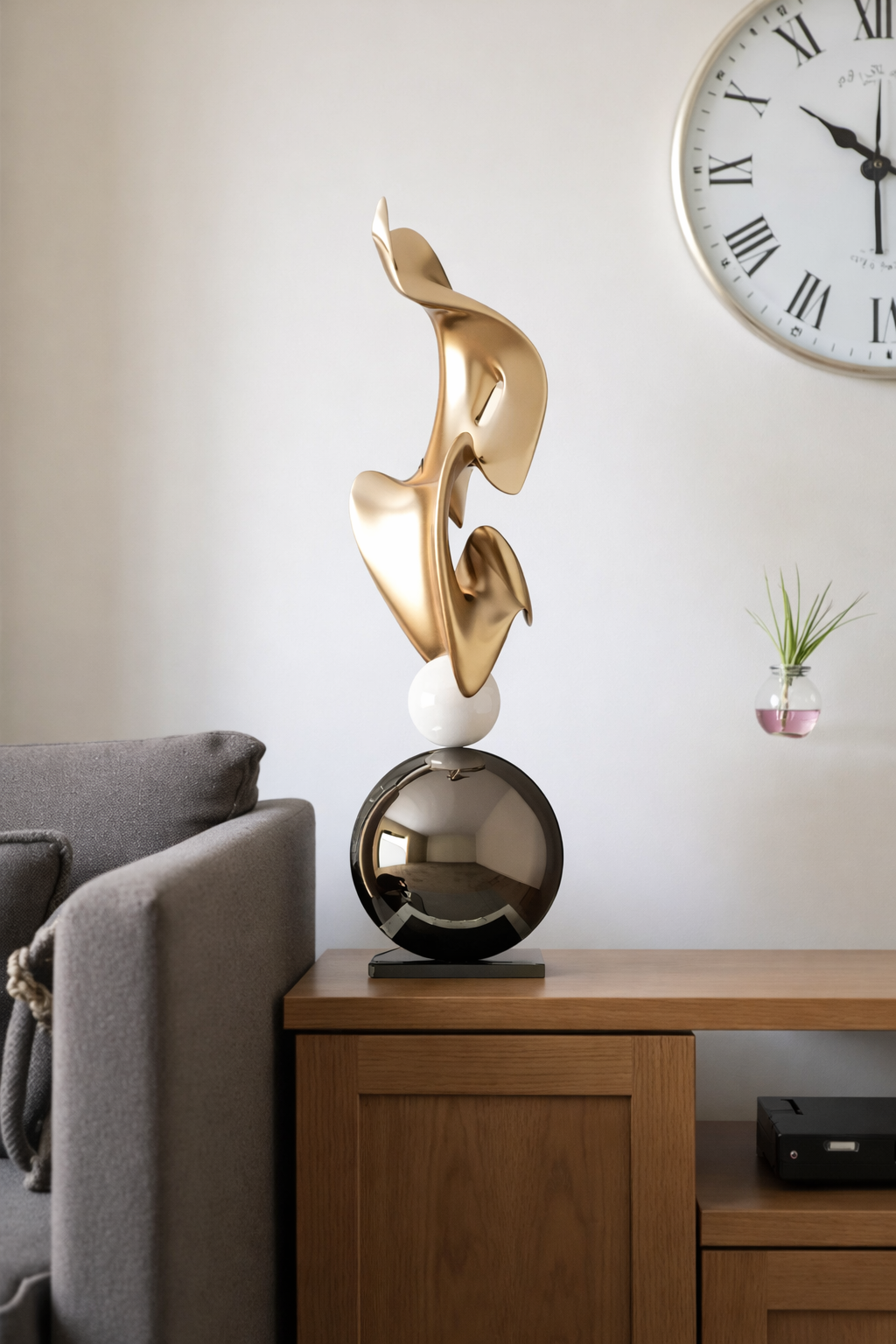 Gold abstract sculpture displayed beside a modern console table