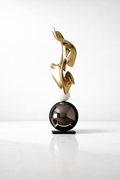 Modern abstract floor sculpture in gold with black sphere
