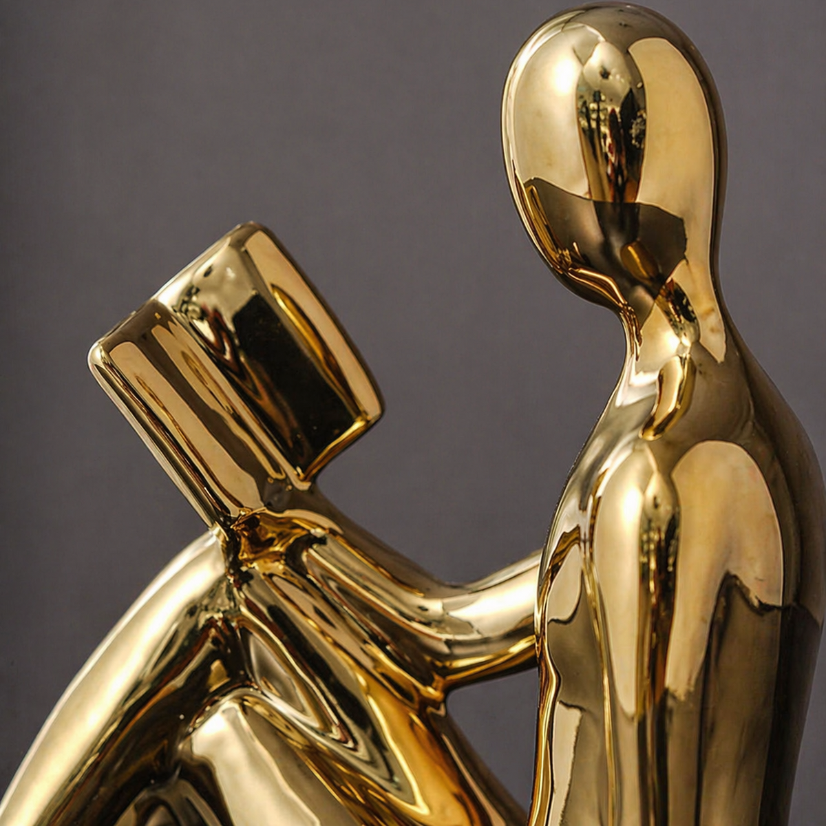 Close-up of gold minimalist reading figure bookend