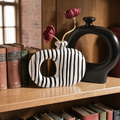 Modern ceramic donut vases styled on a bookshelf