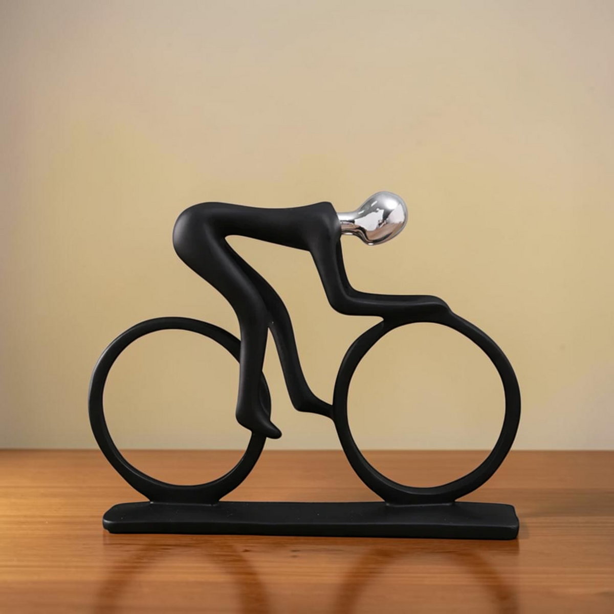 Modern minimalist cyclist sculpture with black bicycle form and metallic head
