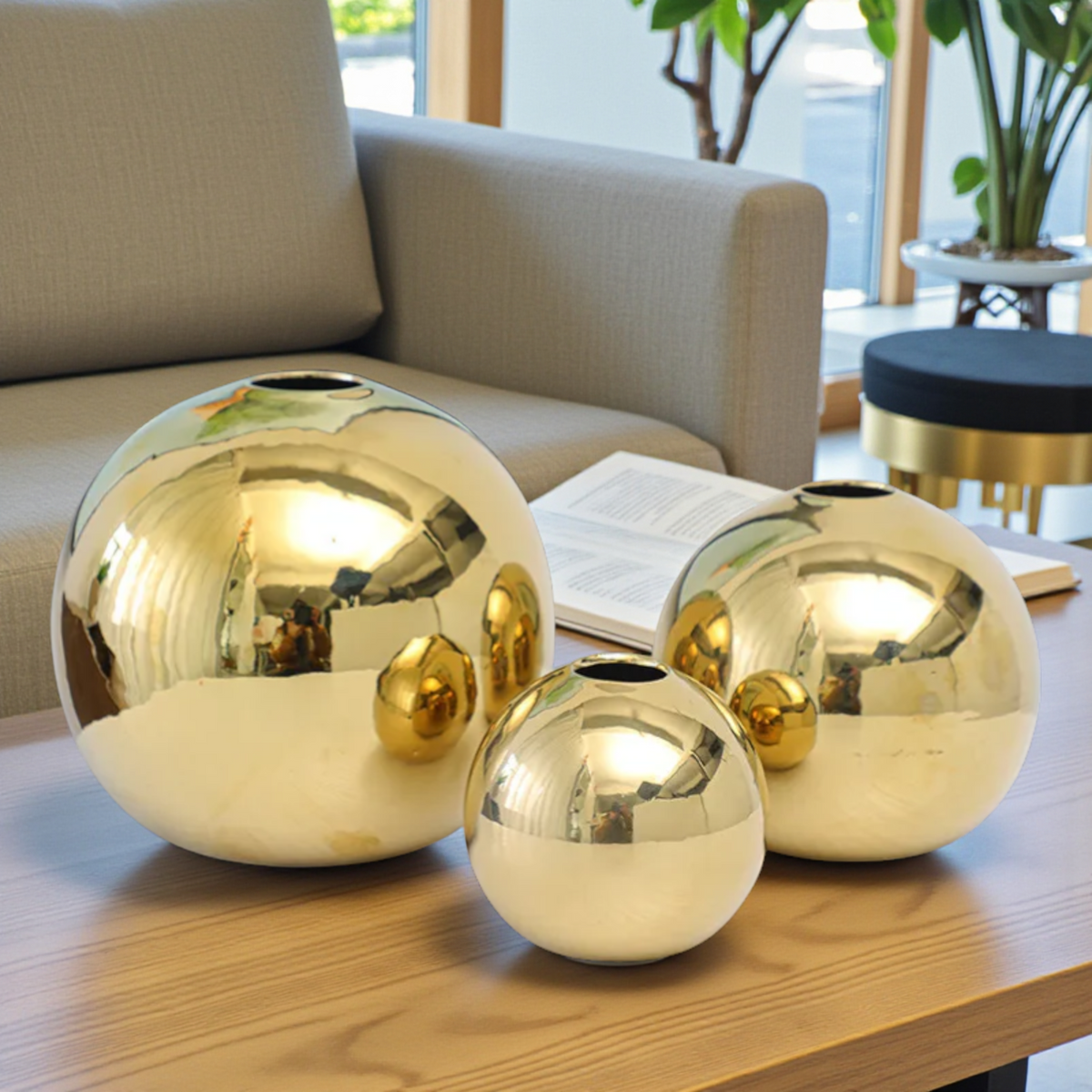 Modern gold sphere ceramic vase set on coffee table