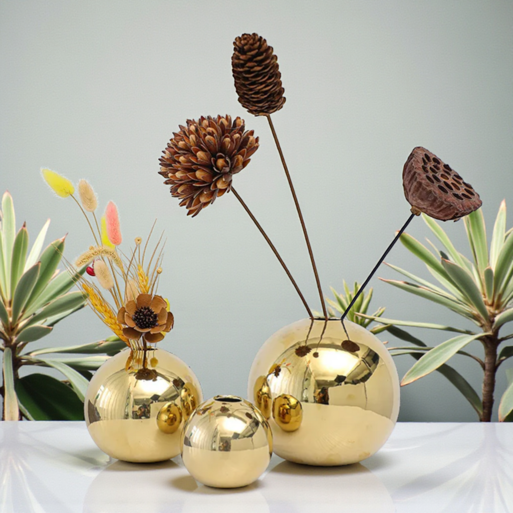 Gold sphere ceramic vases with dried floral stems