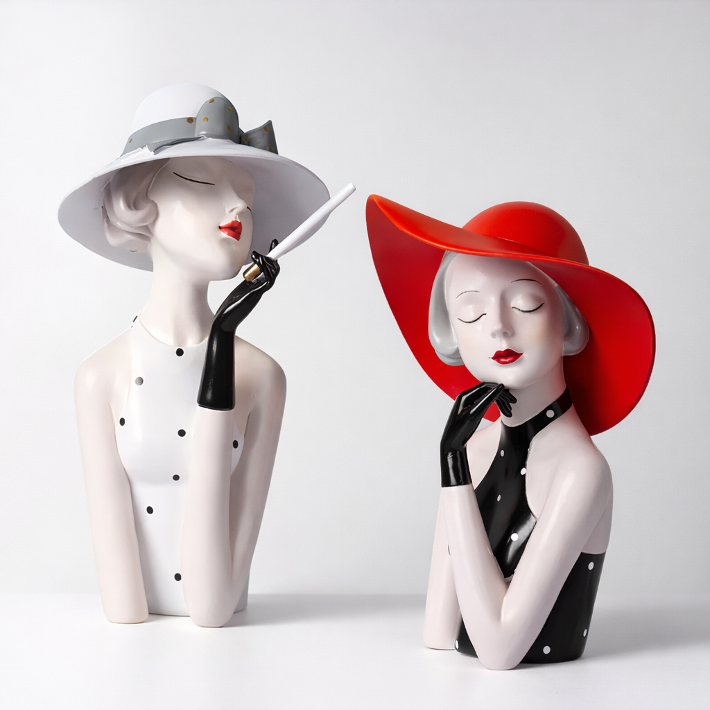 Two modern lady sculptures on a white background