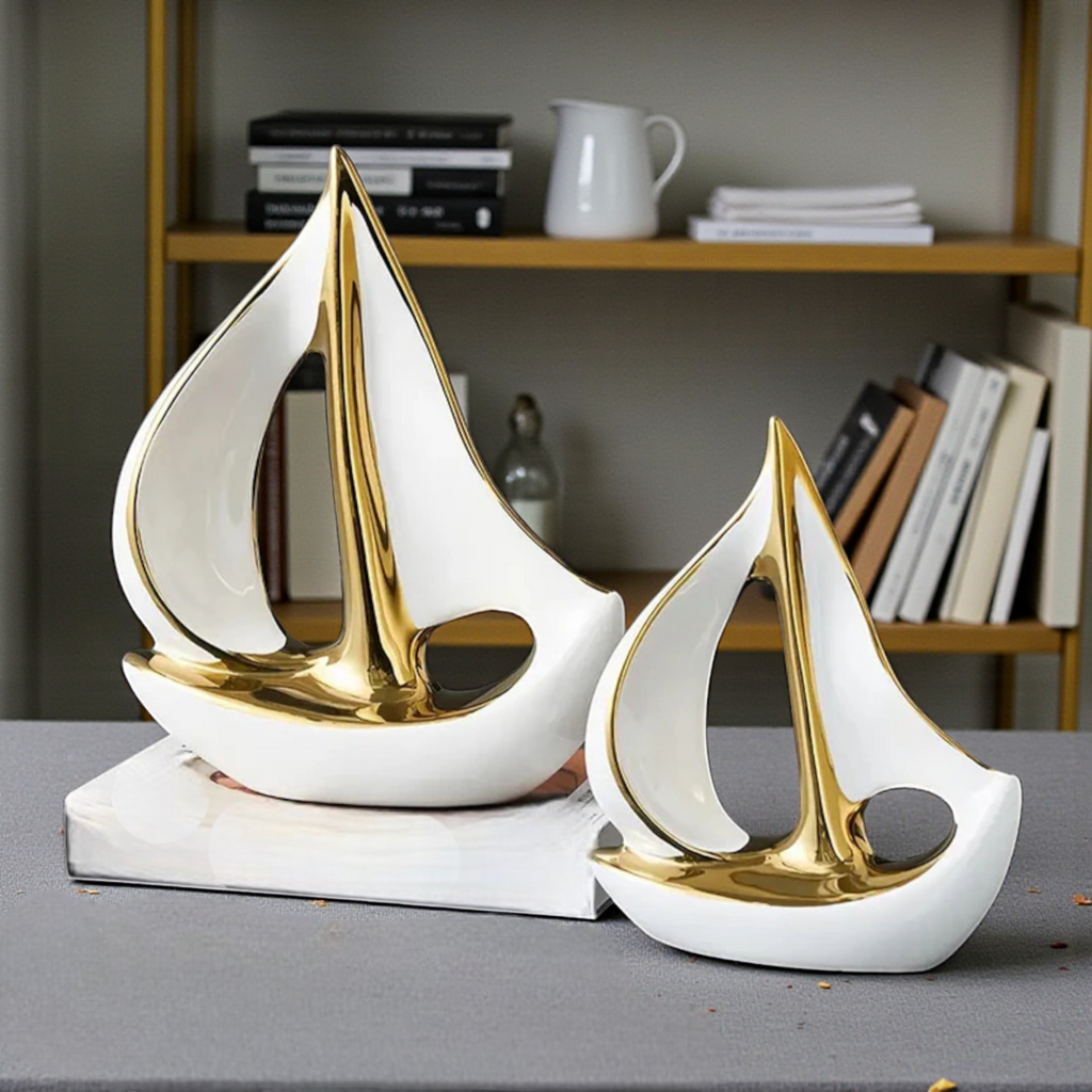 Modern white and gold ceramic sailboat sculptures in two sizes