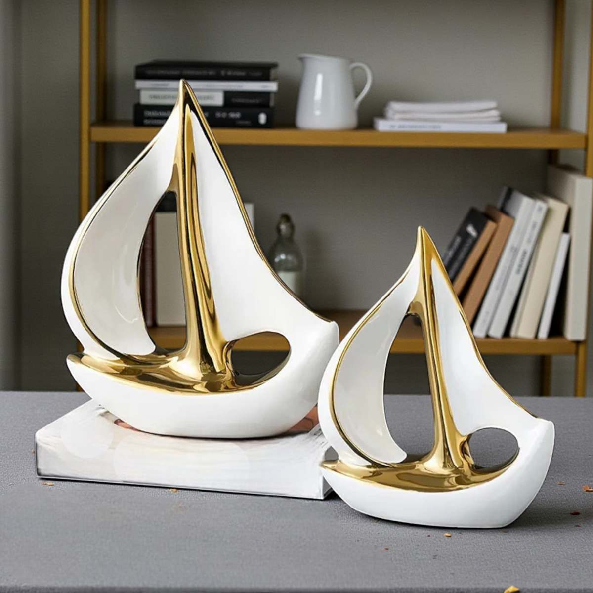 Modern white and gold ceramic sailboat sculptures in two sizes