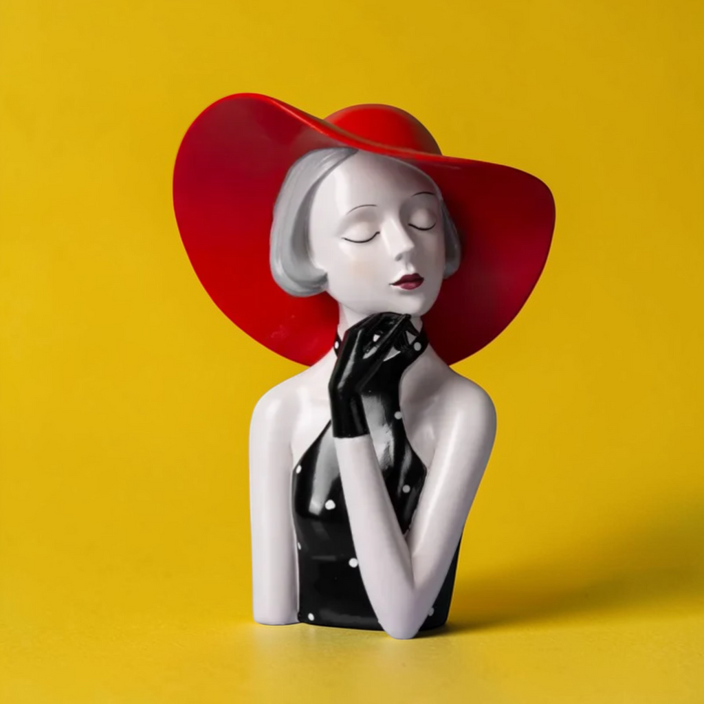 Red hat lady sculpture on yellow background