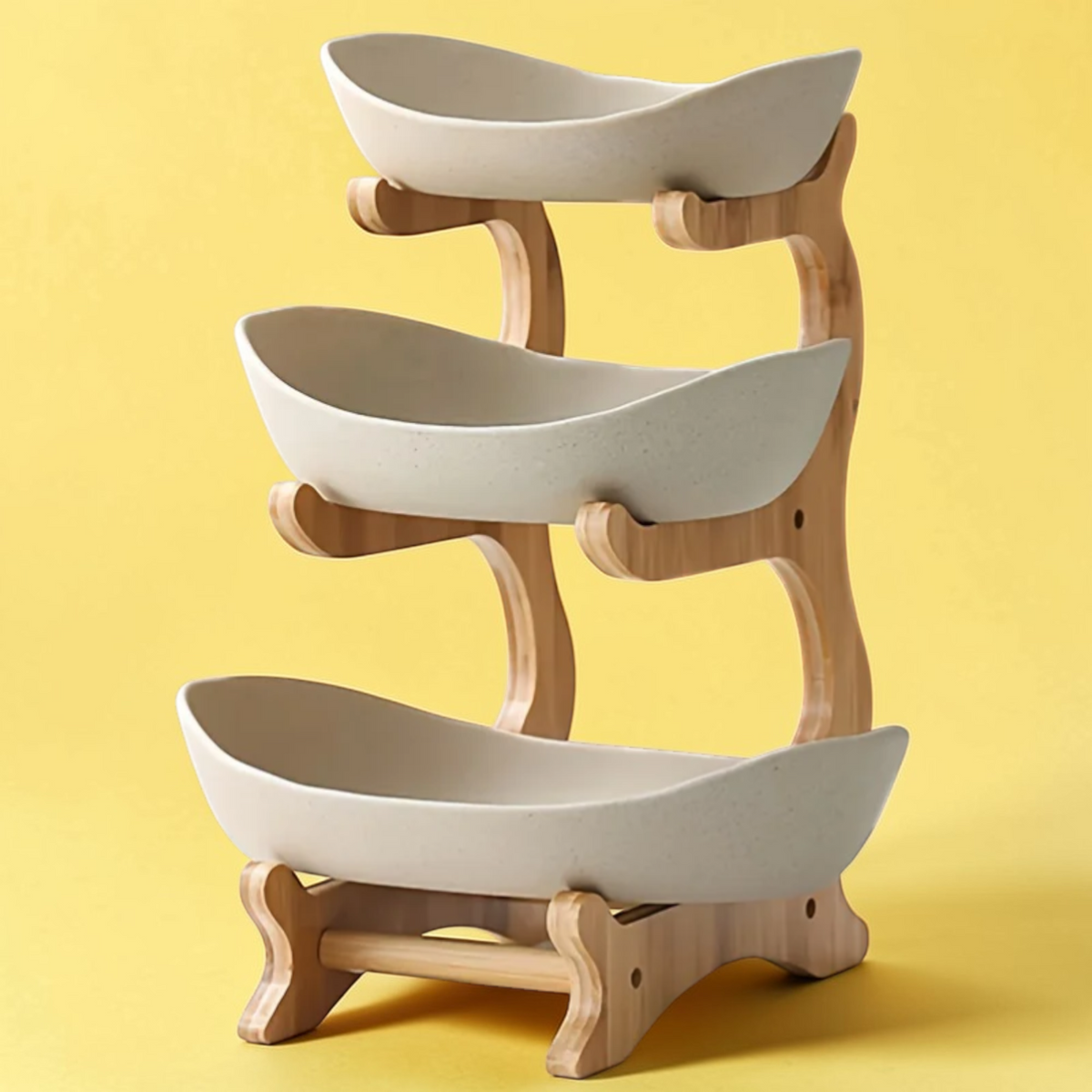 Dark green three tier plastic fruit bowl stand with wooden frame in kitchen