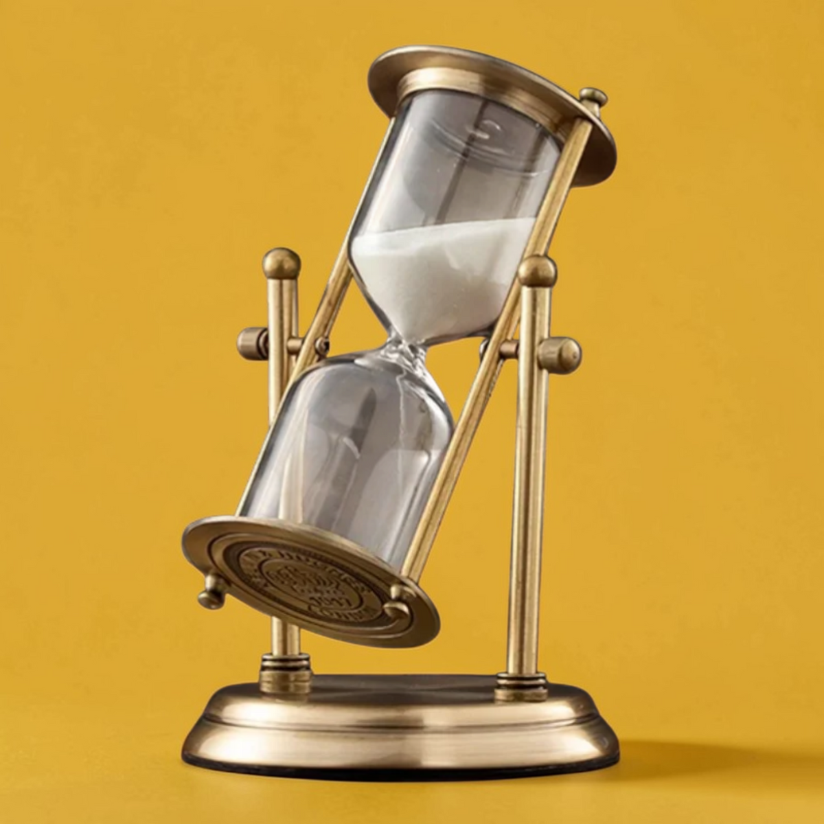 Vintage brass hourglass timer angled view